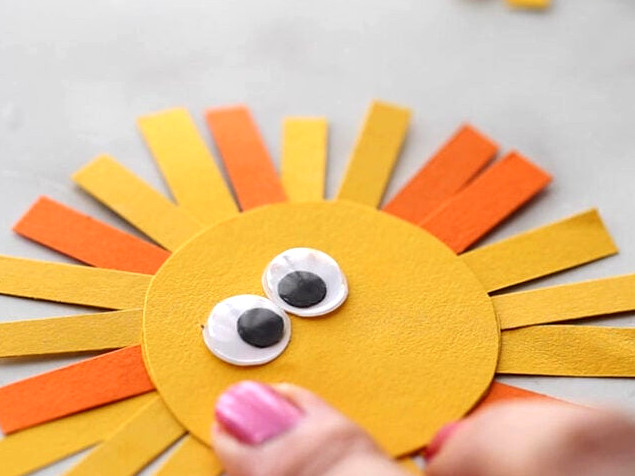 Glue googly eyes to lion head