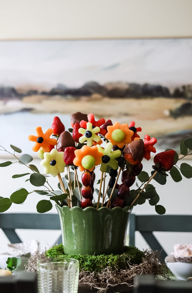 DIY edible fruit arrangement and fruit flowers in a display.