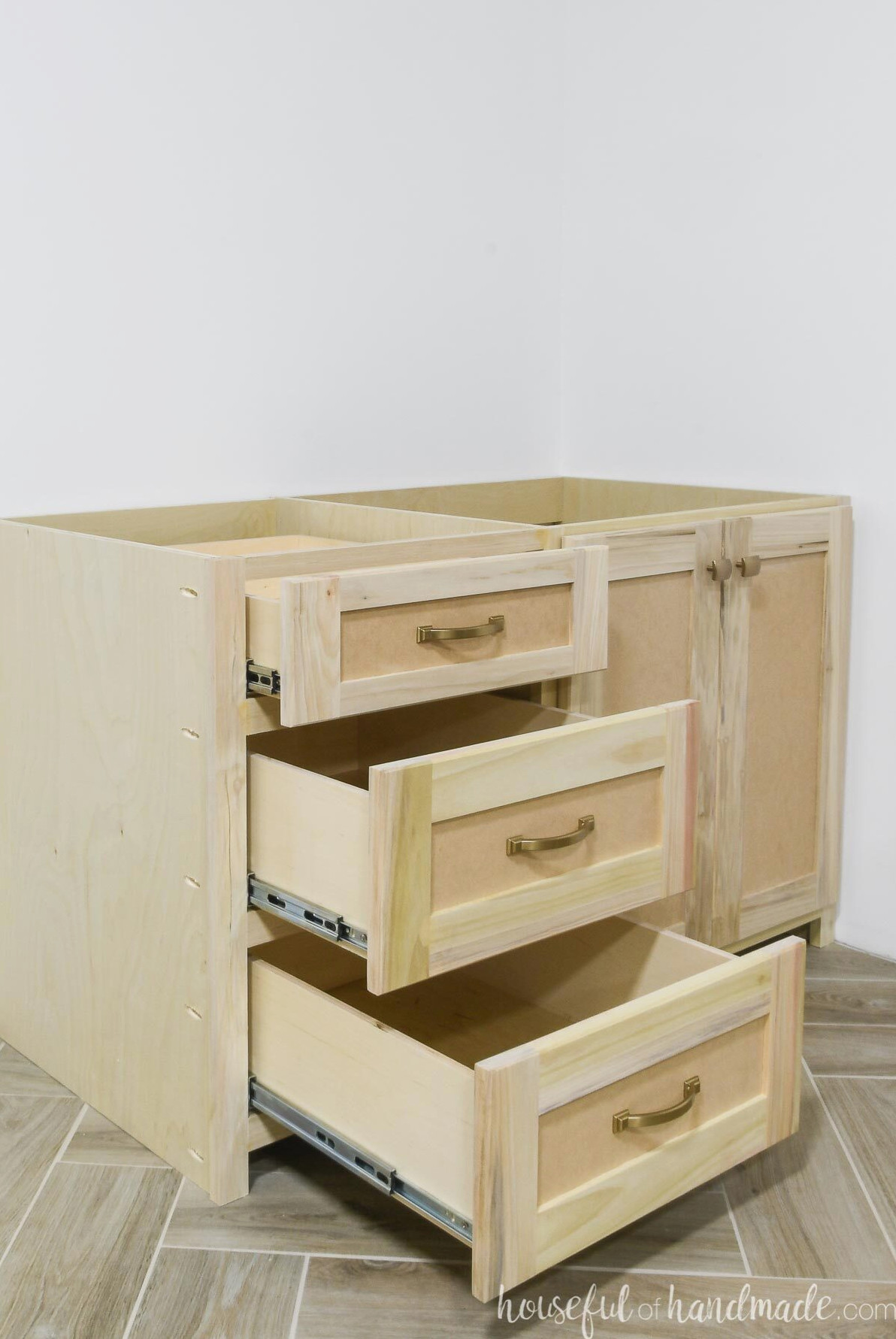 Cabinet segment for the DIY desk with three drawers extended to display the drawer slides along the sides.
