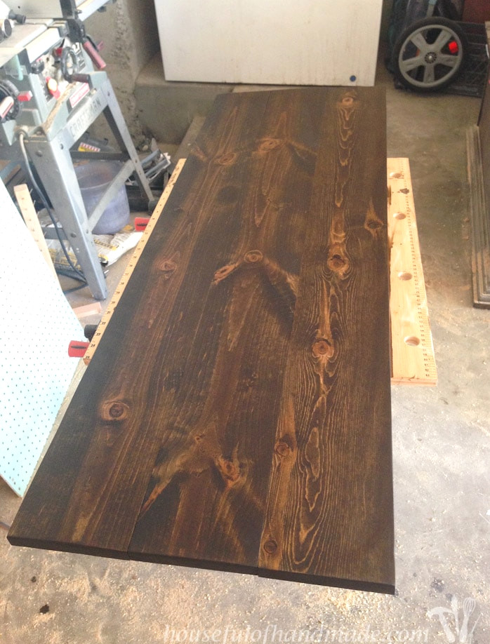 Dark stained console table top.