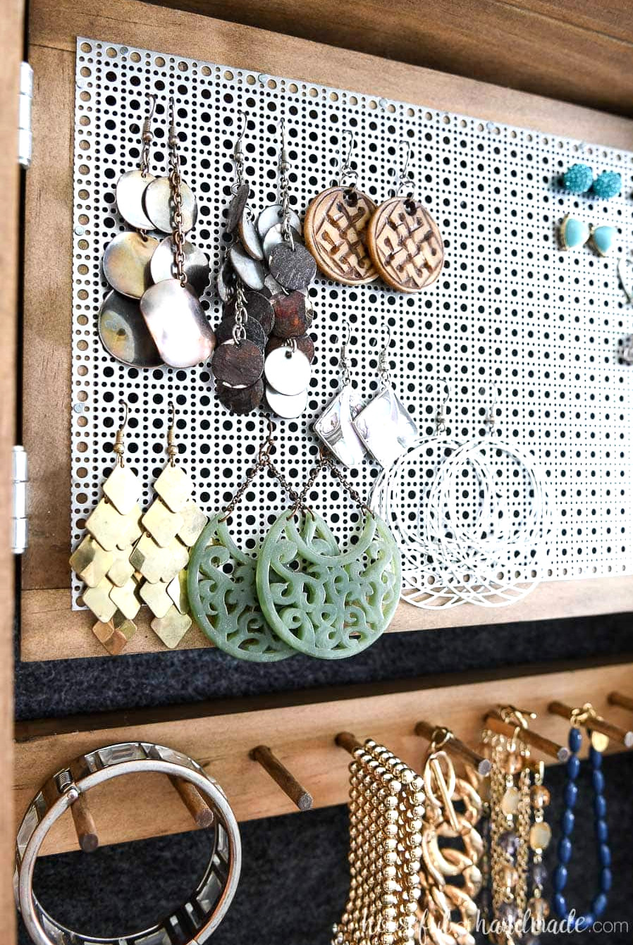 Close up of the hinged earring rack in the hidden jewelry cabinet.