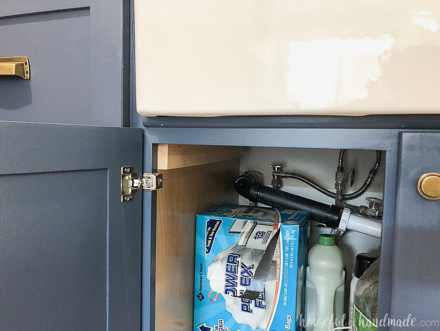 Close up view of the 2x4 sink supports inside the farmhouse sink cabinet.