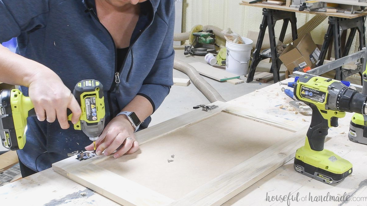 Attaching concealed hinges to the back of the cabinet door.