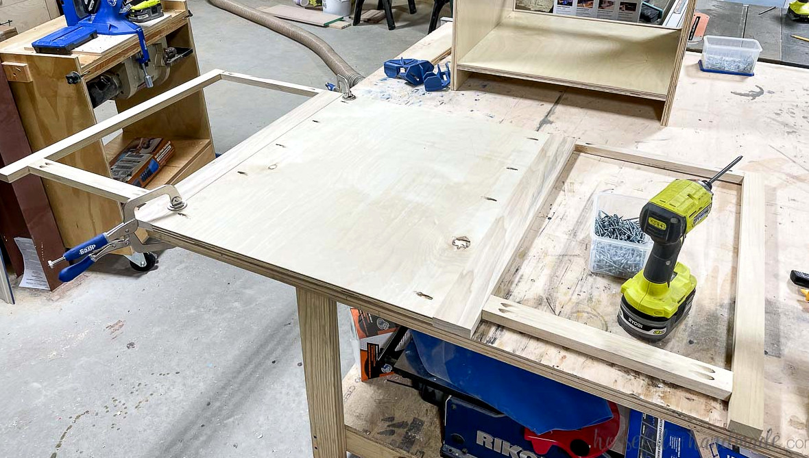 Two blind corner cabinet face frames secured to a plywood panel.