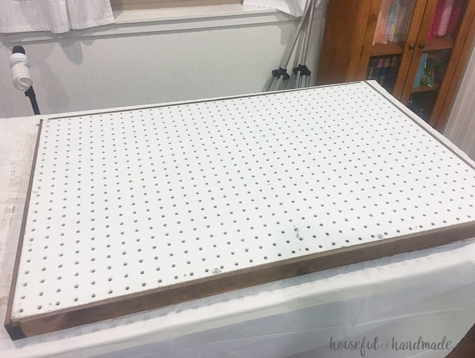 Create the perfect place to organize your most used supplies! Learn how to hang pegboard so it is removable if needed. Housefulofhandmade.com | Craft organization ideas | Craft room remodel | Pegboard organization | $100 Room Challenge | Easy woodworking | Easy building plans | Free Building plans
