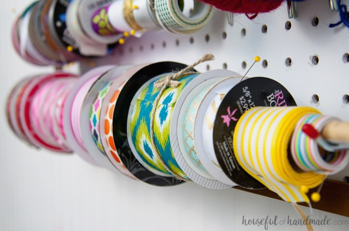 Create the perfect place to organize your most used supplies! Learn how to hang pegboard so it is removable if needed. Housefulofhandmade.com | Craft organization ideas | Craft room remodel | Pegboard organization | $100 Room Challenge | Easy woodworking | Easy building plans | Free Building plans