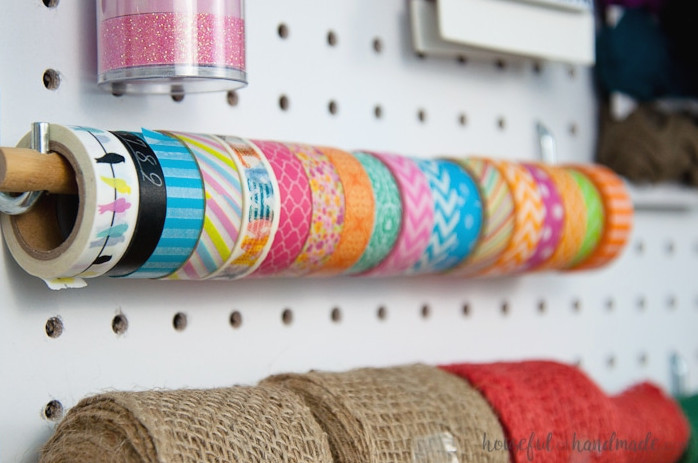 Create the perfect place to organize your most used supplies! Learn how to hang pegboard so it is removable if needed. Housefulofhandmade.com | Craft organization ideas | Craft room remodel | Pegboard organization | $100 Room Challenge | Easy woodworking | Easy building plans | Free Building plans