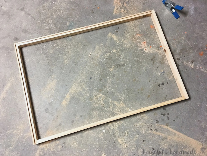 Create the perfect place to organize your most used supplies! Learn how to hang pegboard so it is removable if needed. Housefulofhandmade.com | Craft organization ideas | Craft room remodel | Pegboard organization | $100 Room Challenge | Easy woodworking | Easy building plans | Free Building plans