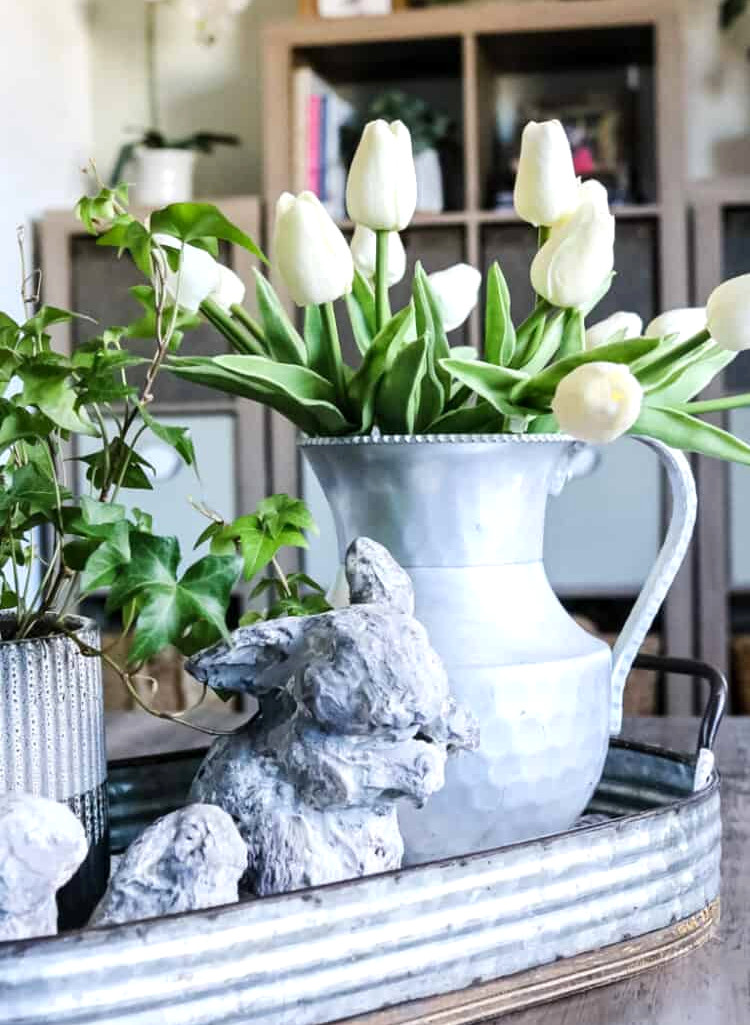 white tulips in a pewter vase