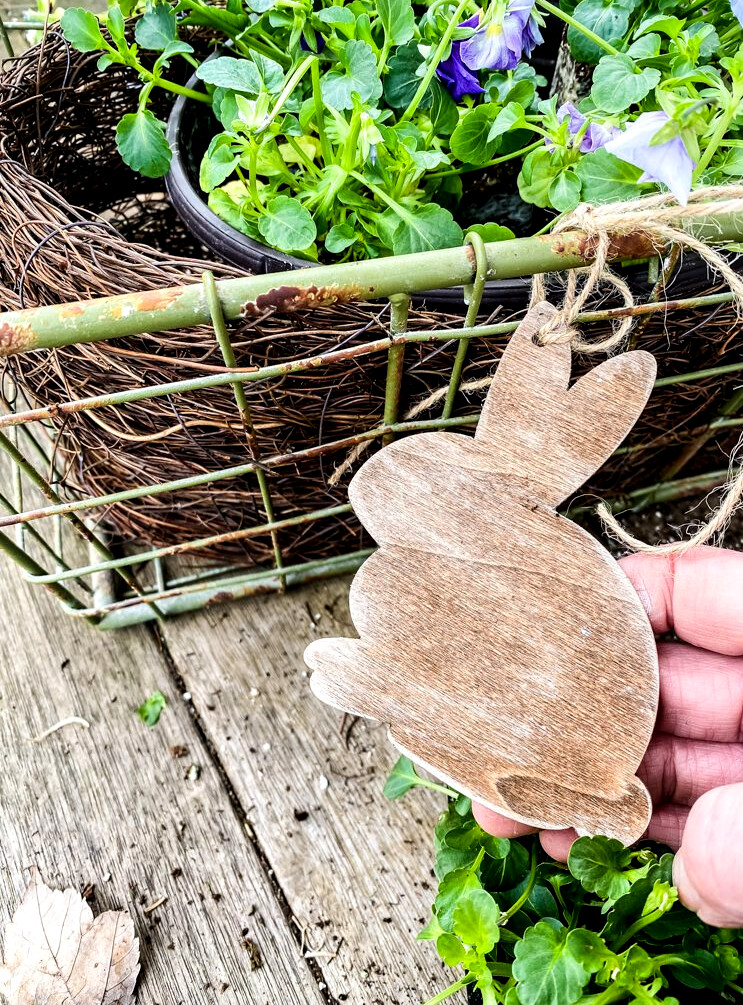 basket of pansies and a wood bunny ornament