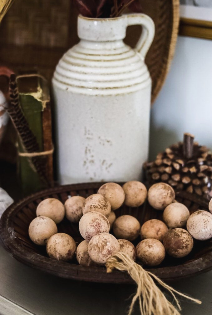 basket of beads, white jug and pumpkin