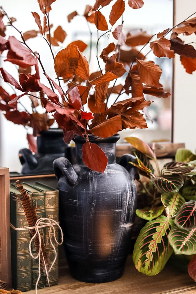 dried leaf stems in black vase