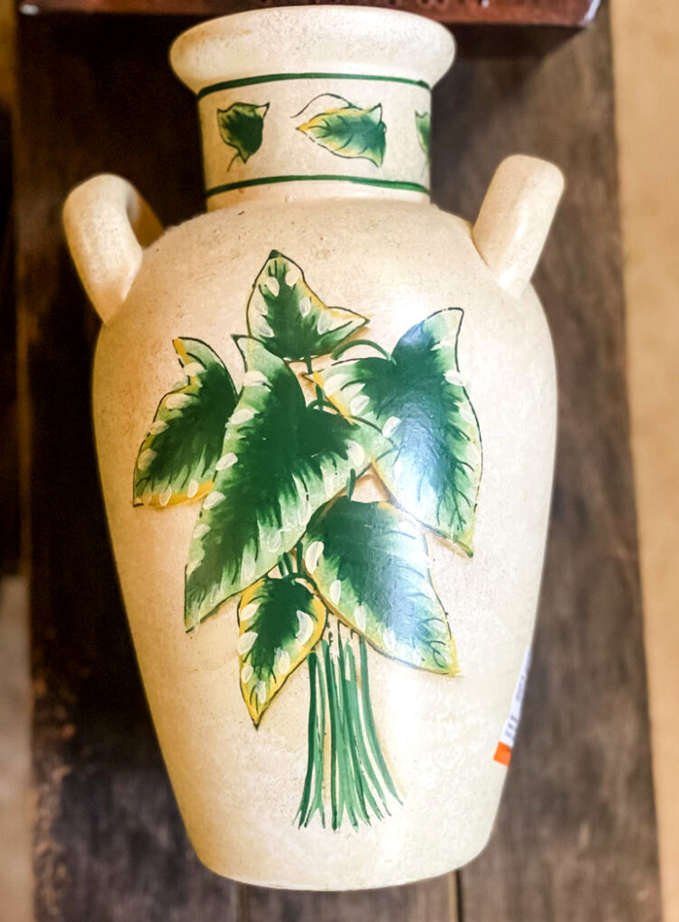thrifted vase decorated with painted leaves