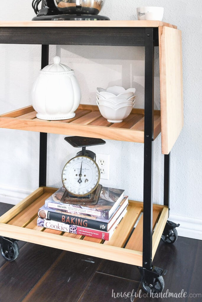 Close-up view of the two natural wood shelves on the contemporary kitchen cart.