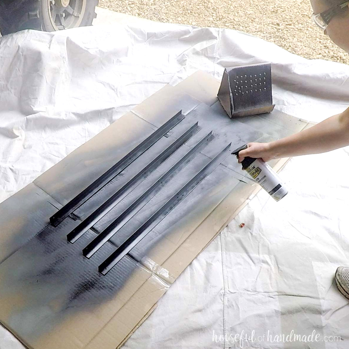 Spray painting angle iron black.