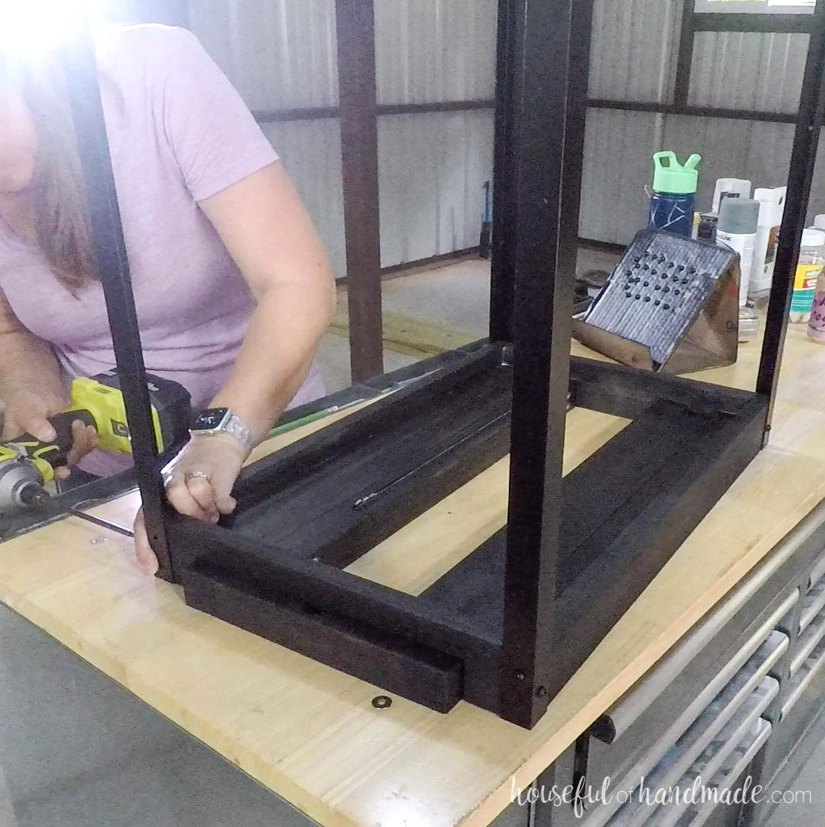 Attaching angle iron to the four corners of the assembled top.