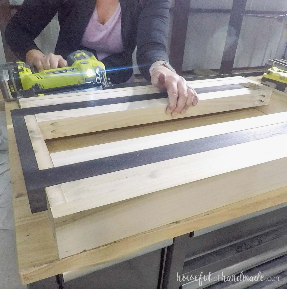 Nailing the outside boards on with a pneumatic nailer.