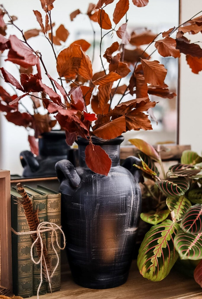 dried leaf stems in black vase