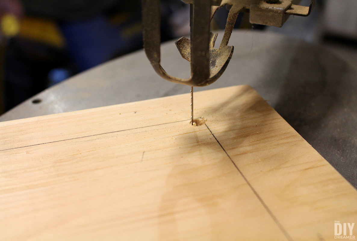 Scroll saw blade inside hole.