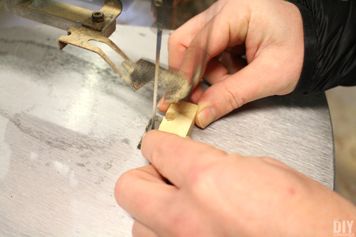 Widening the hole opening with a scroll saw.