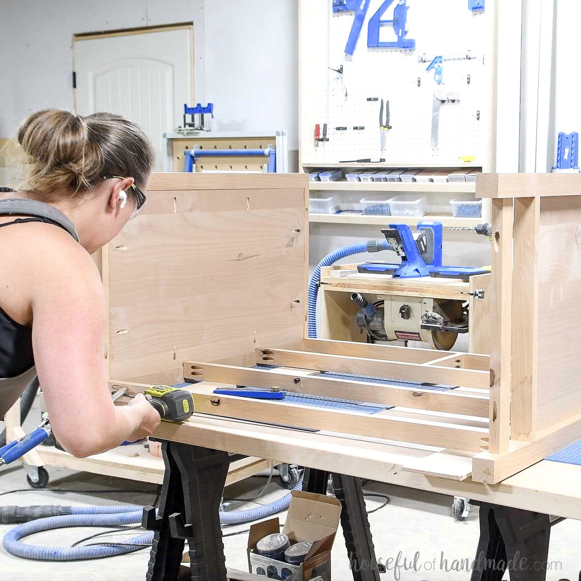 Attaching the lower front trim boards to hold the dresser sides together. 