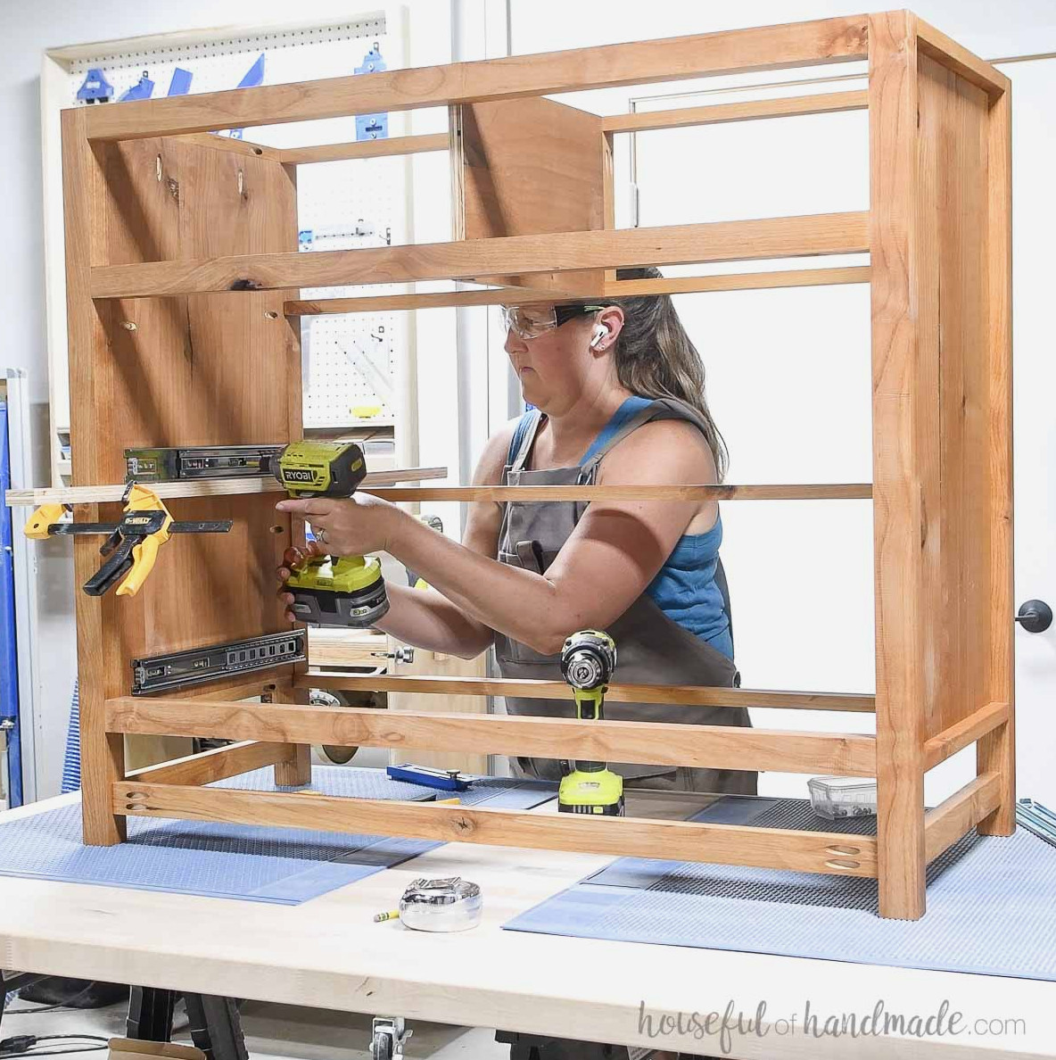 Mounting drawer slides onto the dresser sides. 