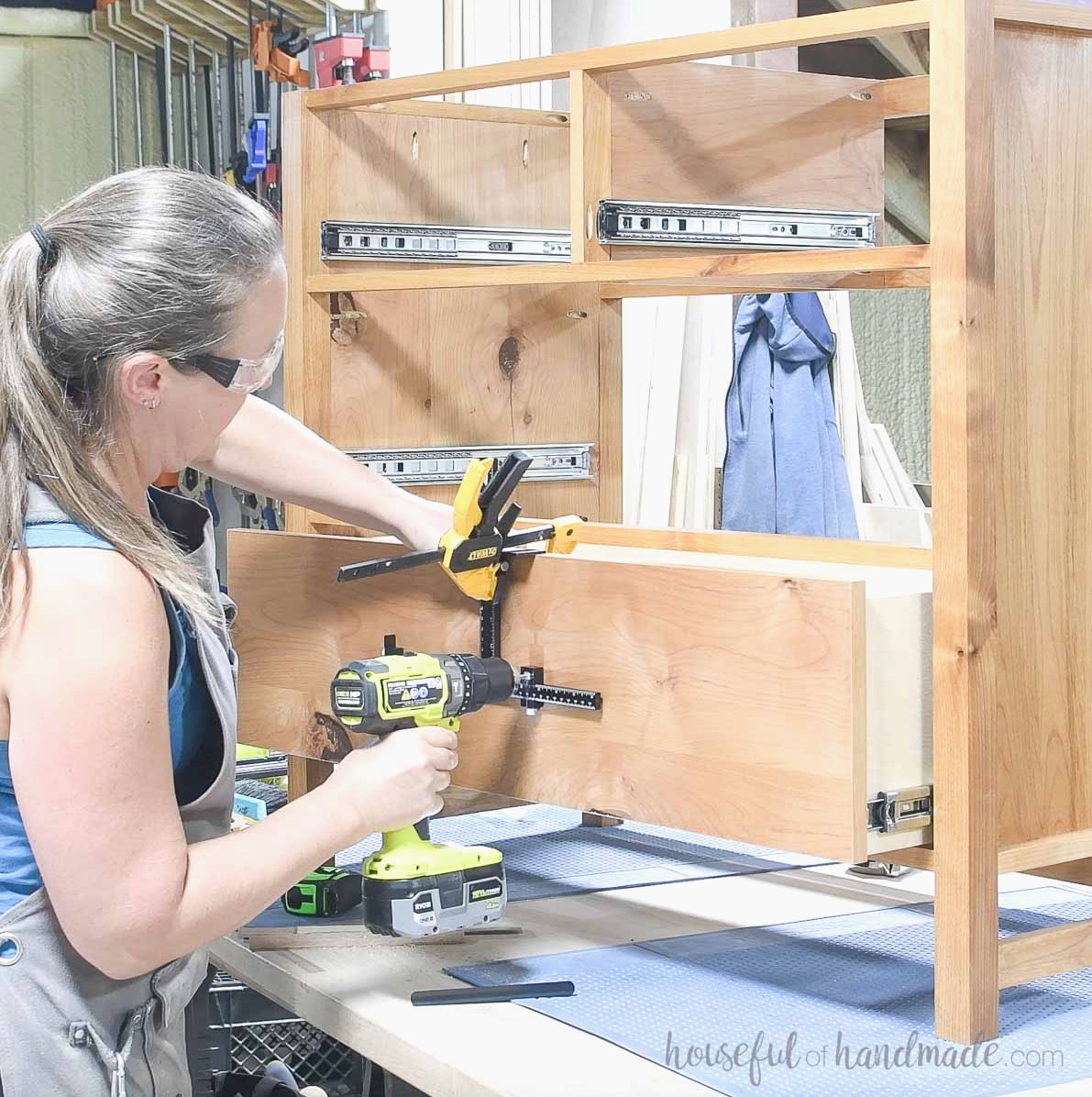 Using a jig to drill holes for the drawer slides. 