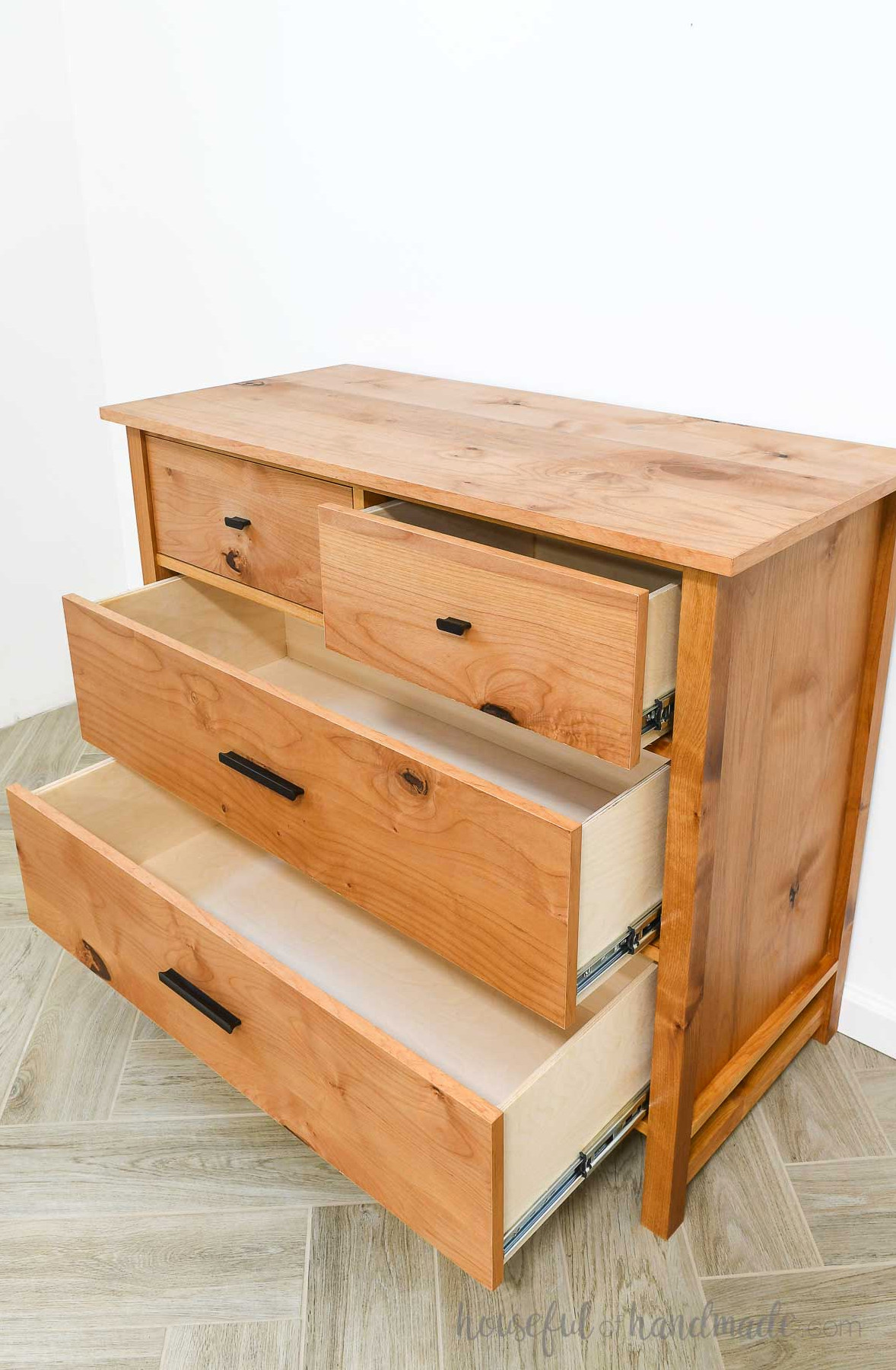 42" wide dresser with all 4 spacious drawers open to display the interior storage. 