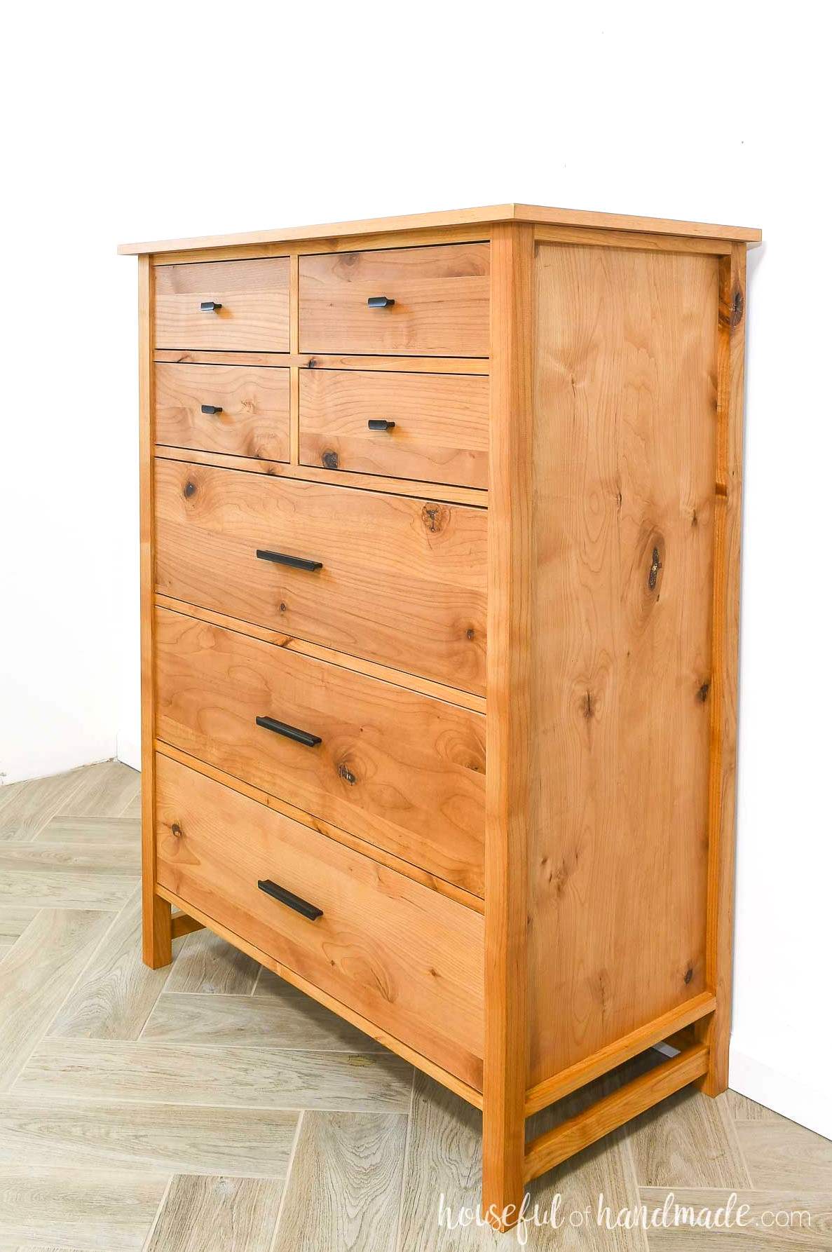 Side view of tall dresser with 2 sizes of drawers.