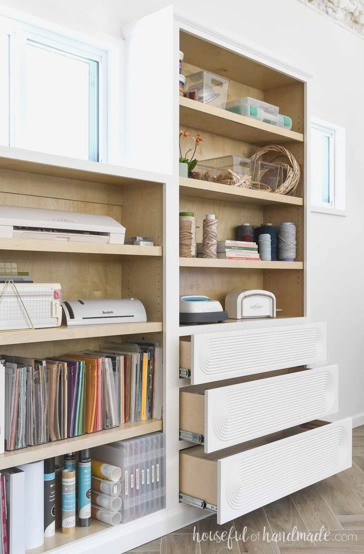 Built in cabinets with drawers on one side open showing the drawer boxes.