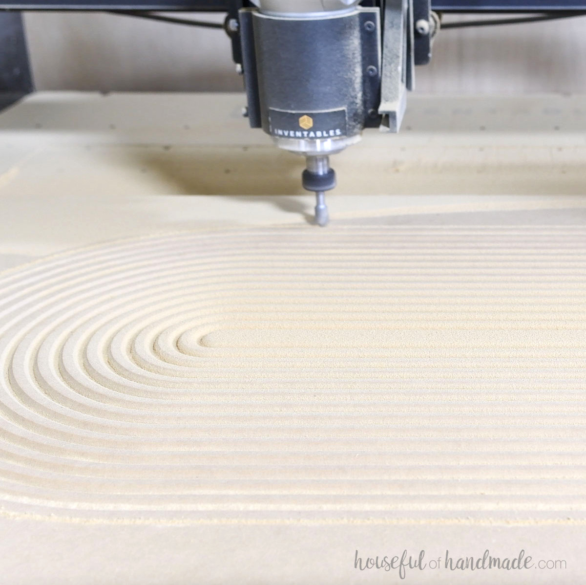 Using a CNC to carve an arched pattern into cabinet doors.
