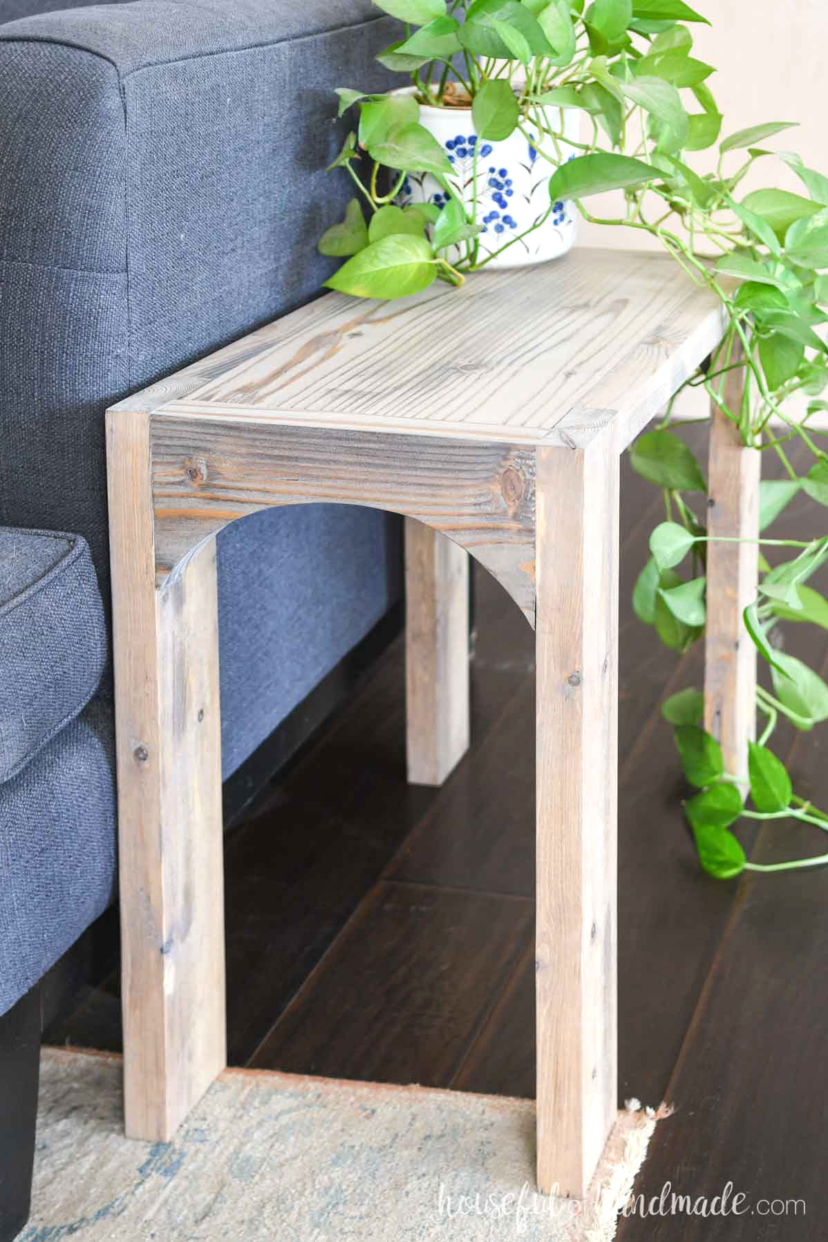 End table made from 2x boards with a bleached or washed wood finish.