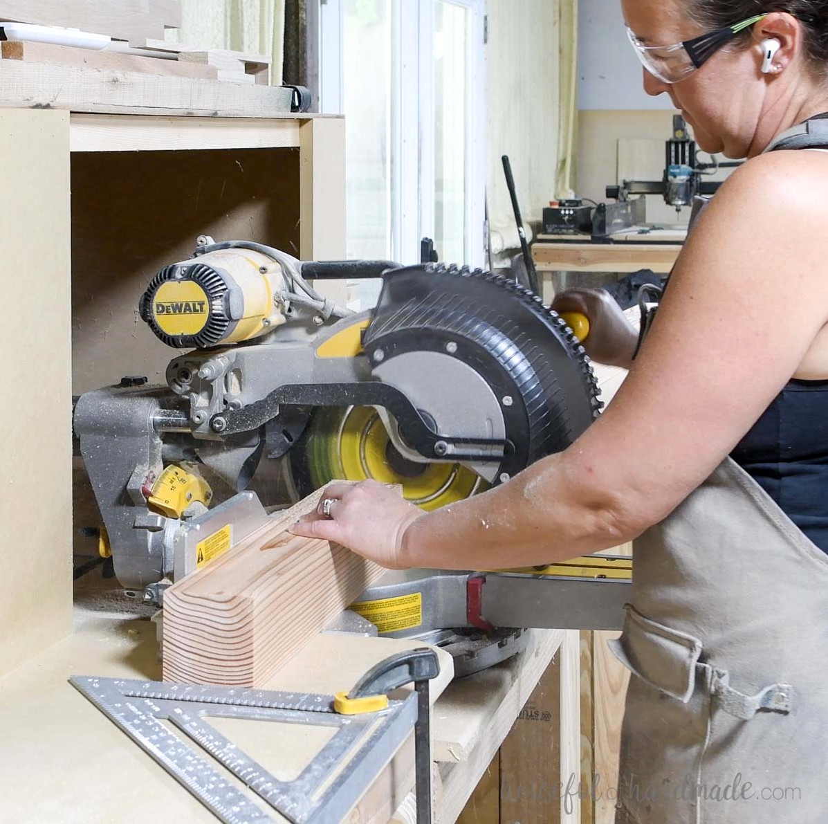 Cutting a 4x4 board on a miter saw. 