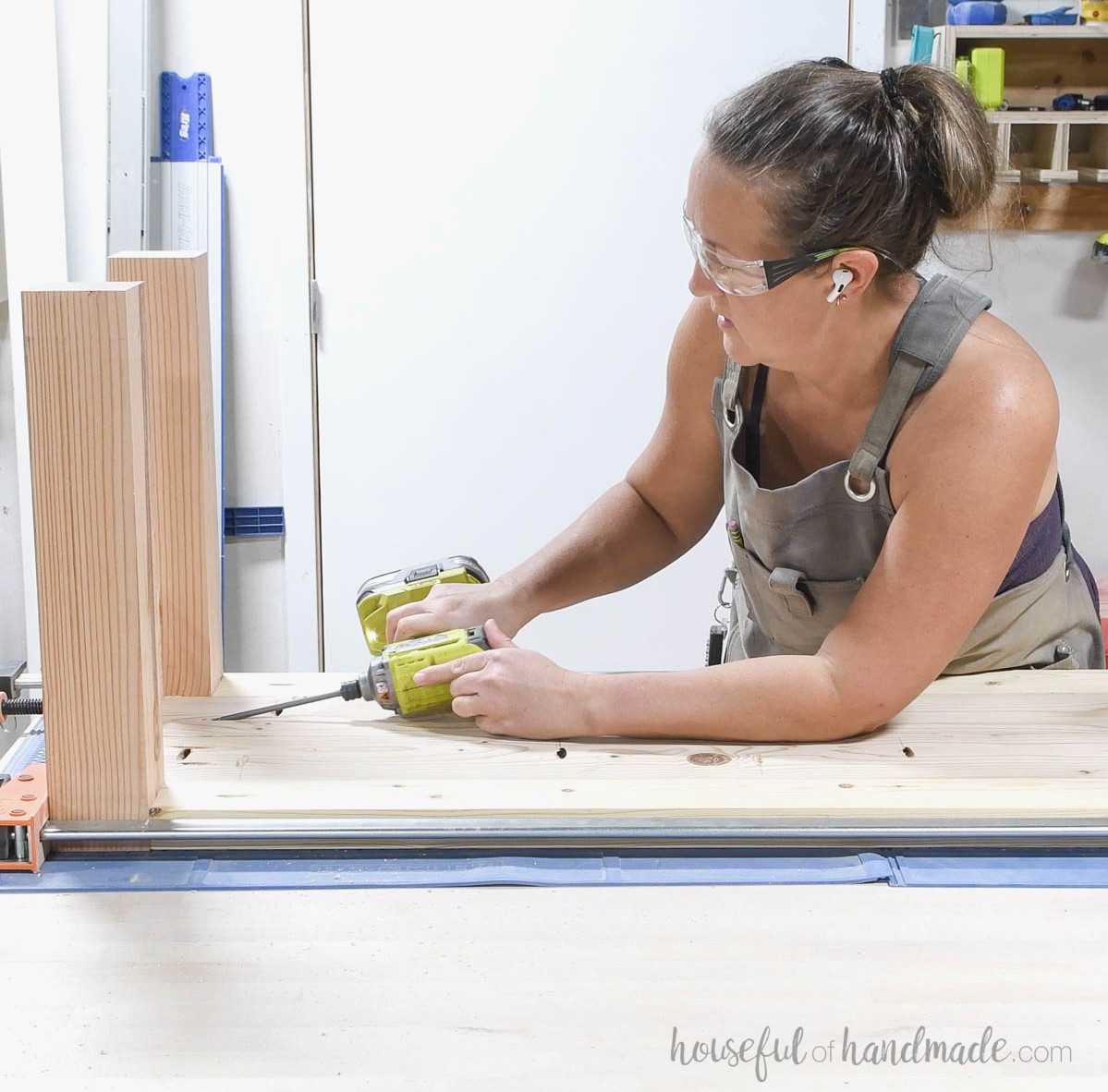 Fastening the top onto the legs.