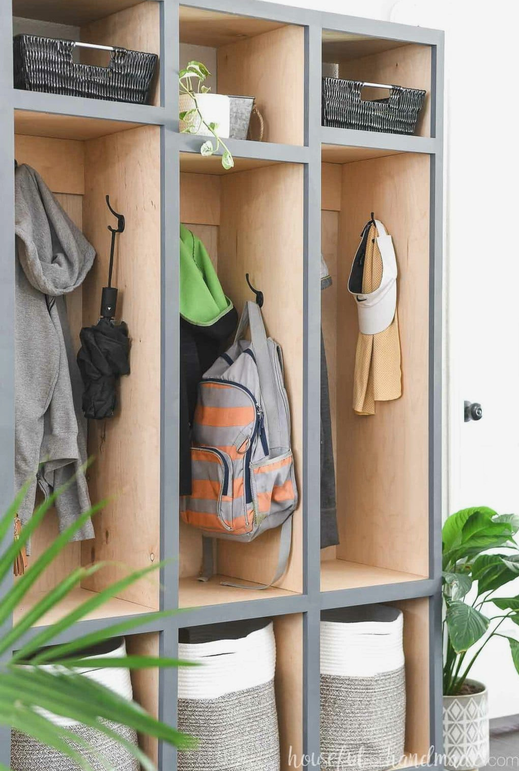 Close view of the side hooks inside the center section of the mudroom storage cabinet. 