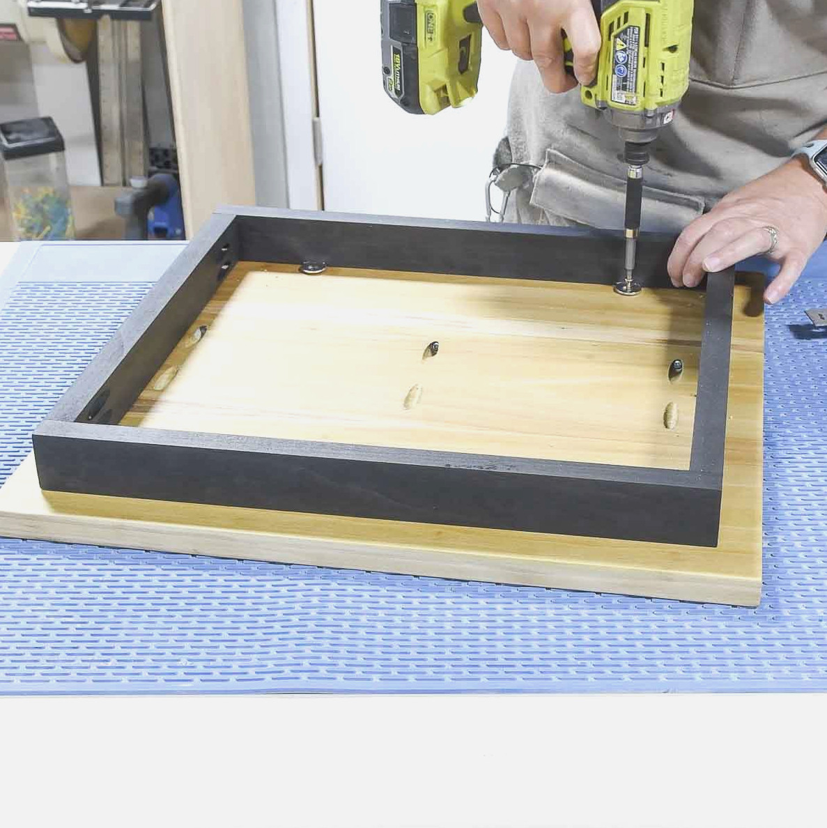 Fastening the apron to the tabletop with figure 8 fasteners.