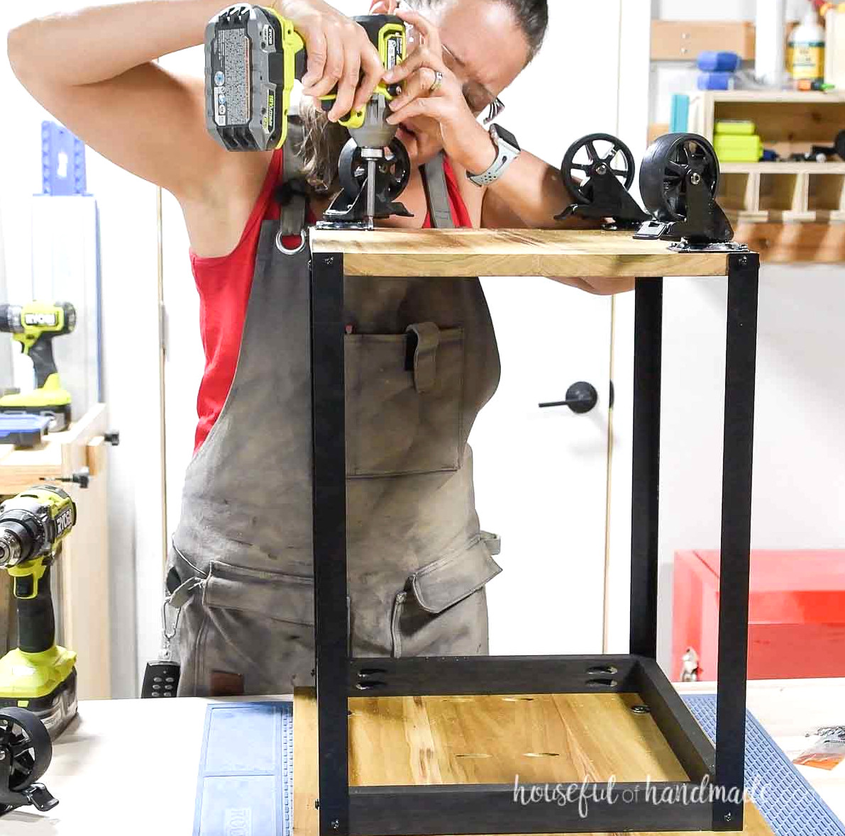 Securing caster wheels underneath the DIY side table.