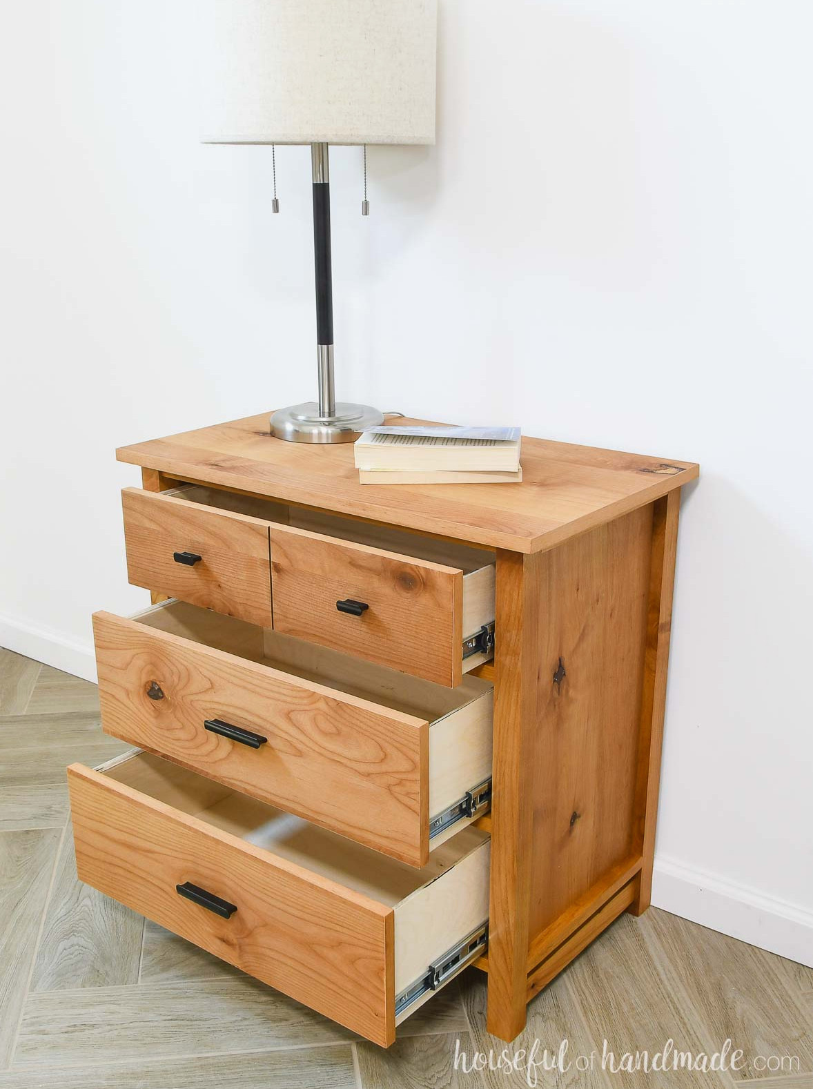 Nightstand with 3 drawers partially open, revealing the plywood drawer boxes. 