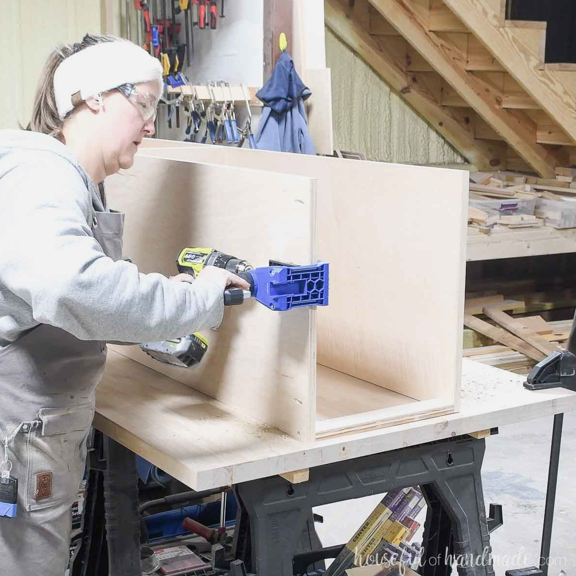 Creating pocket holes in the closet section top with a portable pocket hole jig. 