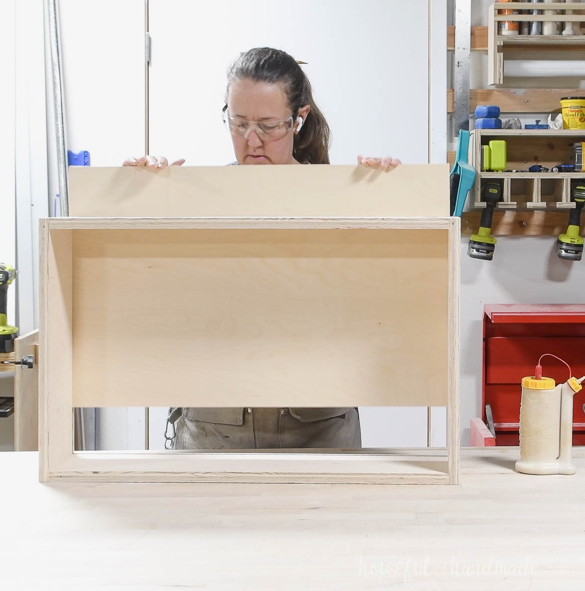 Sliding the bottom panel into the drawer box channel. 