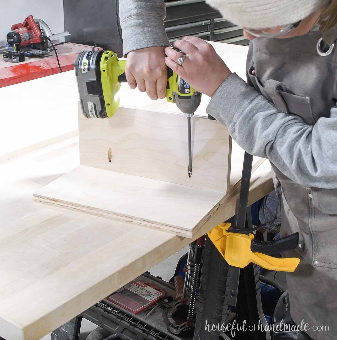 Fastening the toe kick back to create shoe storage space. 