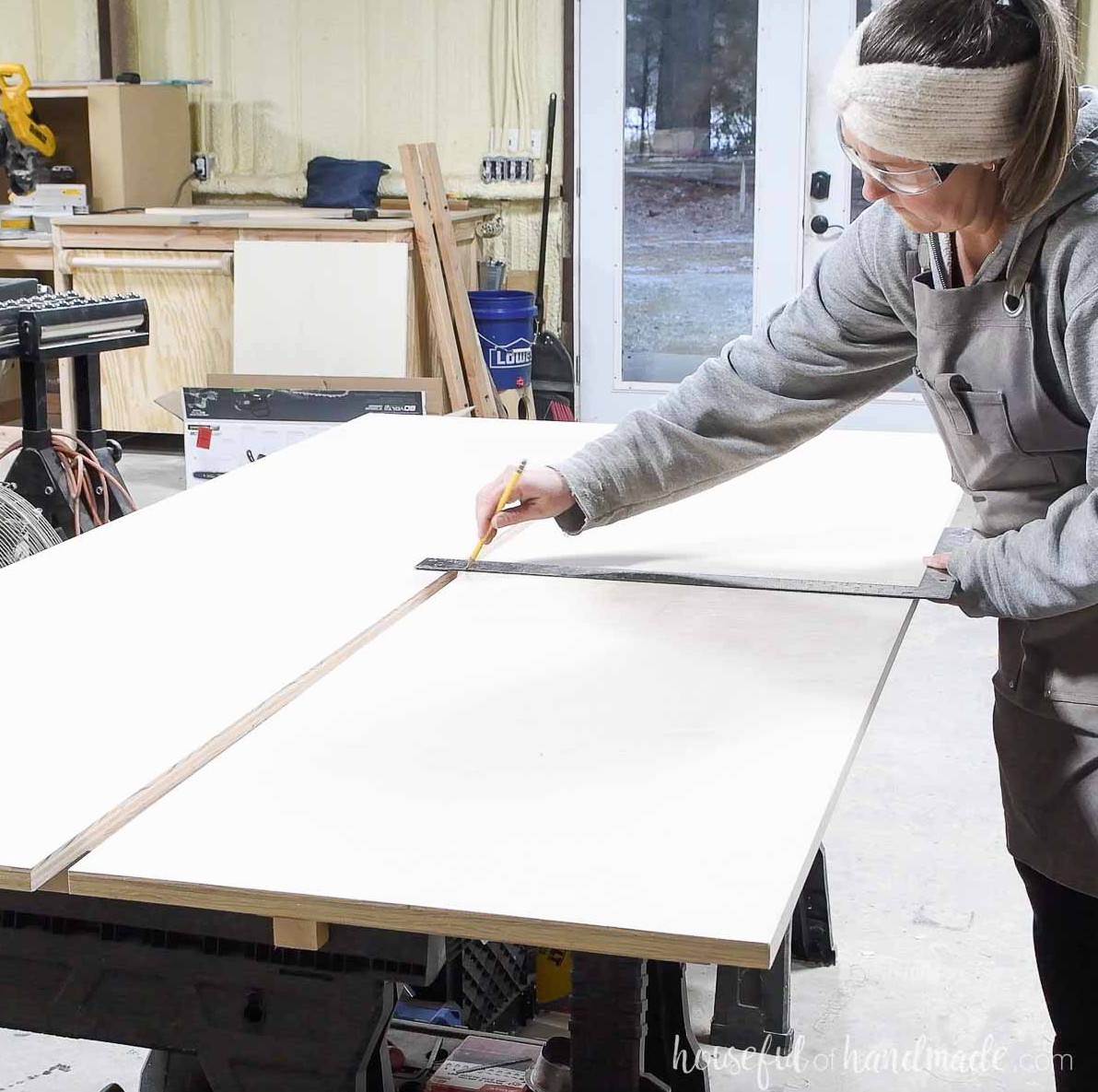 Laying out shelf positions on the side boards. 