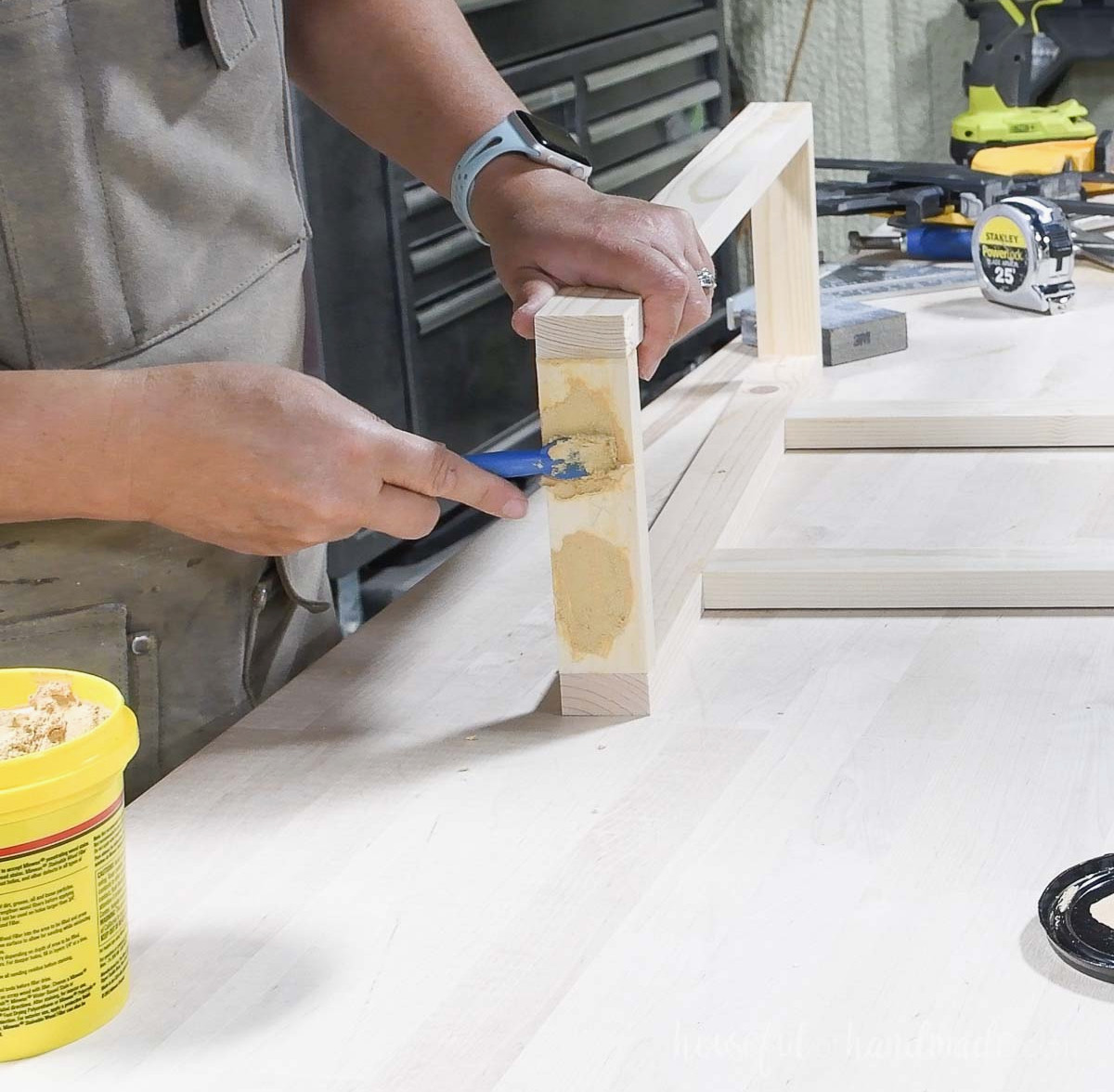 Using wood filler to cover the pocket holes. 