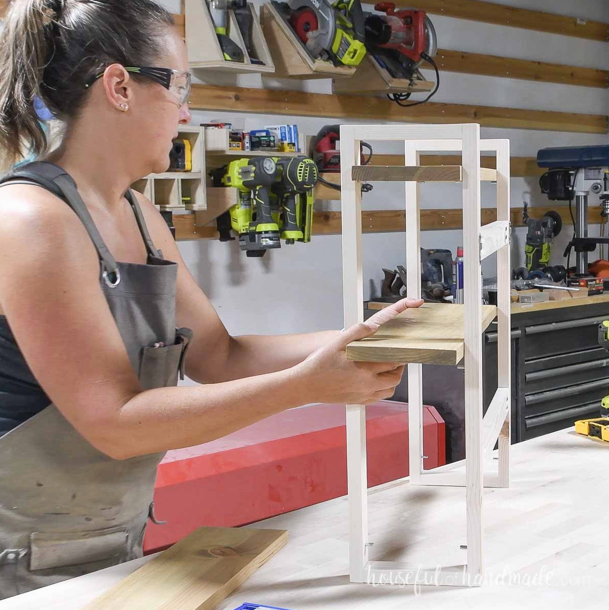 Sliding the completed shelf boards into the frame.