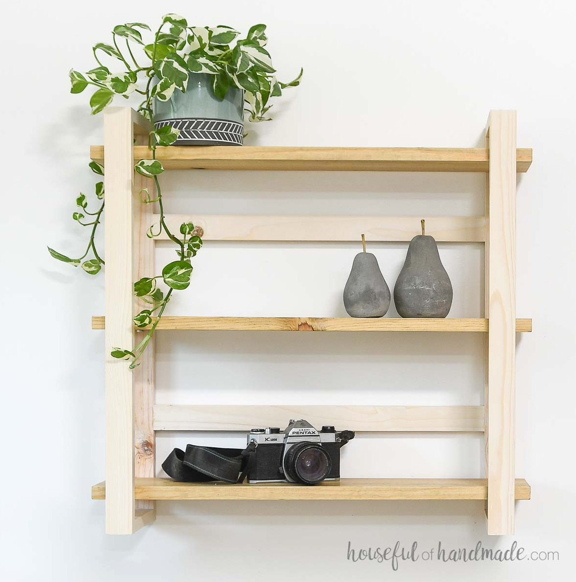 Modern DIY wall shelves simply styled against a white wall. 