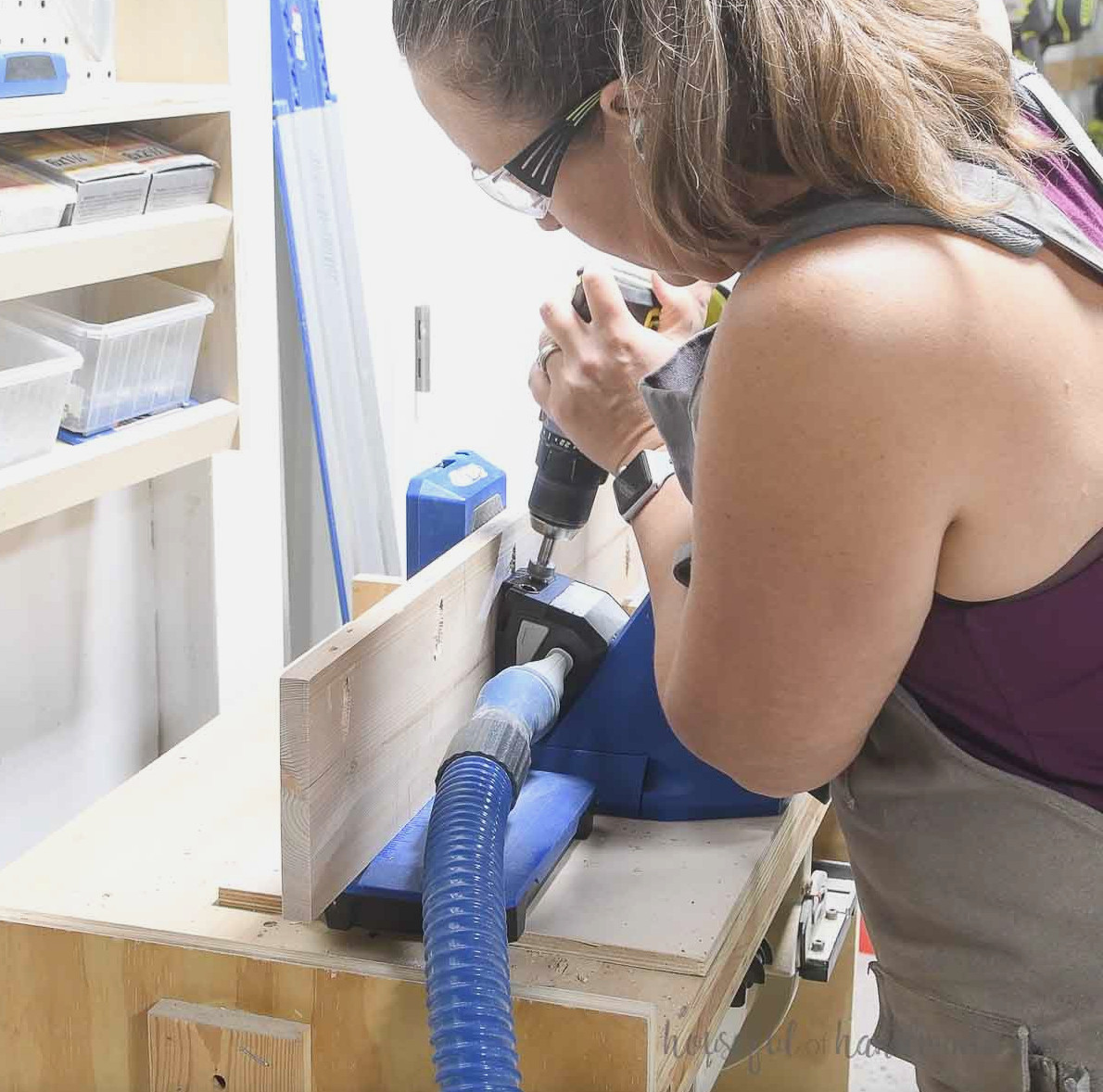 Making a pocket hole with a Kreg jig in one tabletop piece.