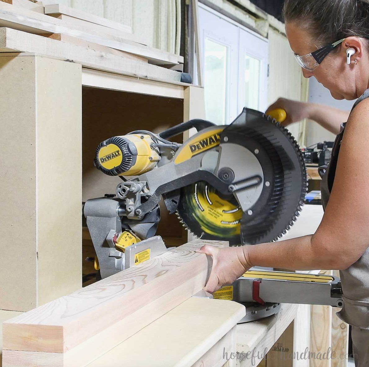 Making angled cuts on the under-seat boards with a miter saw.