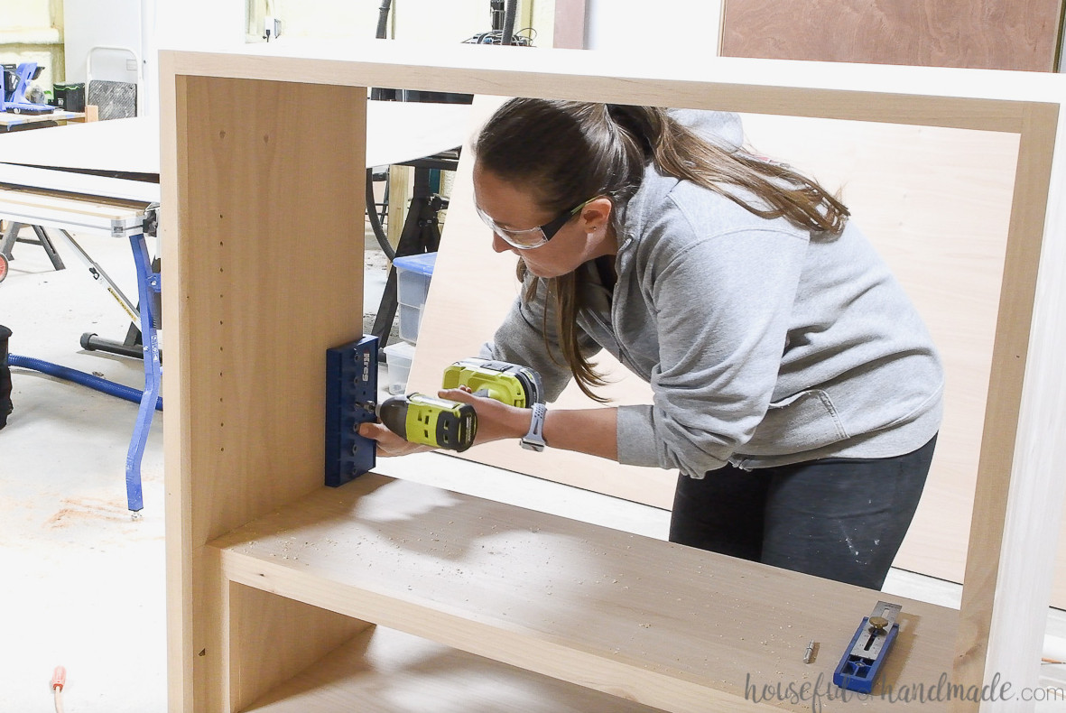 Adding shelf pin holes to the inside of the DIY display cabinet. 