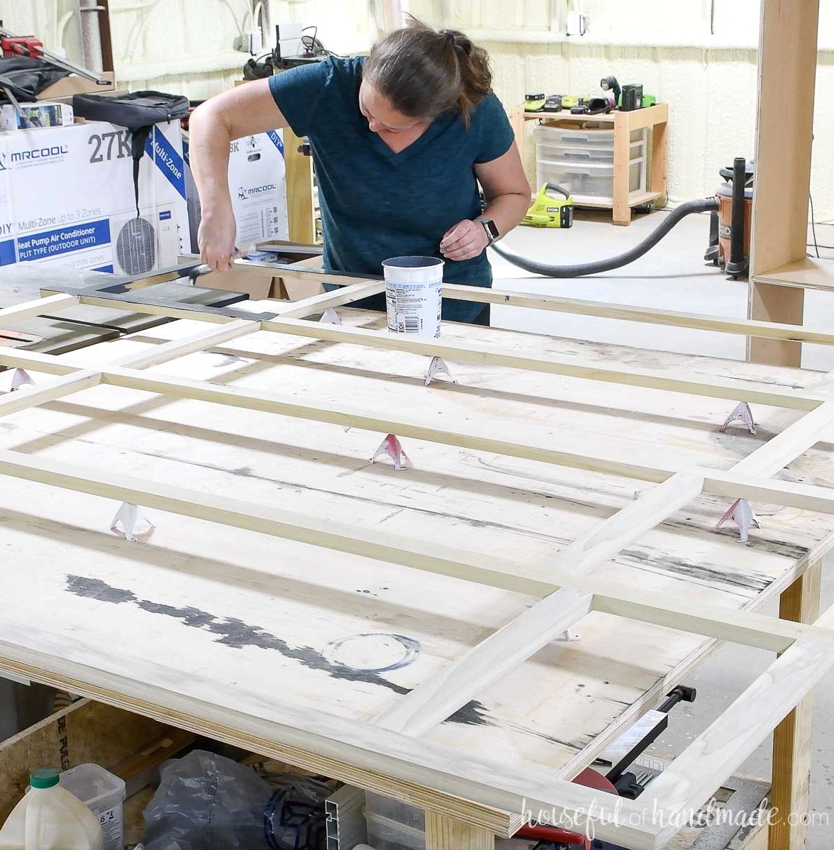 Coating the assembled face frame with navy blue chalk paint. 