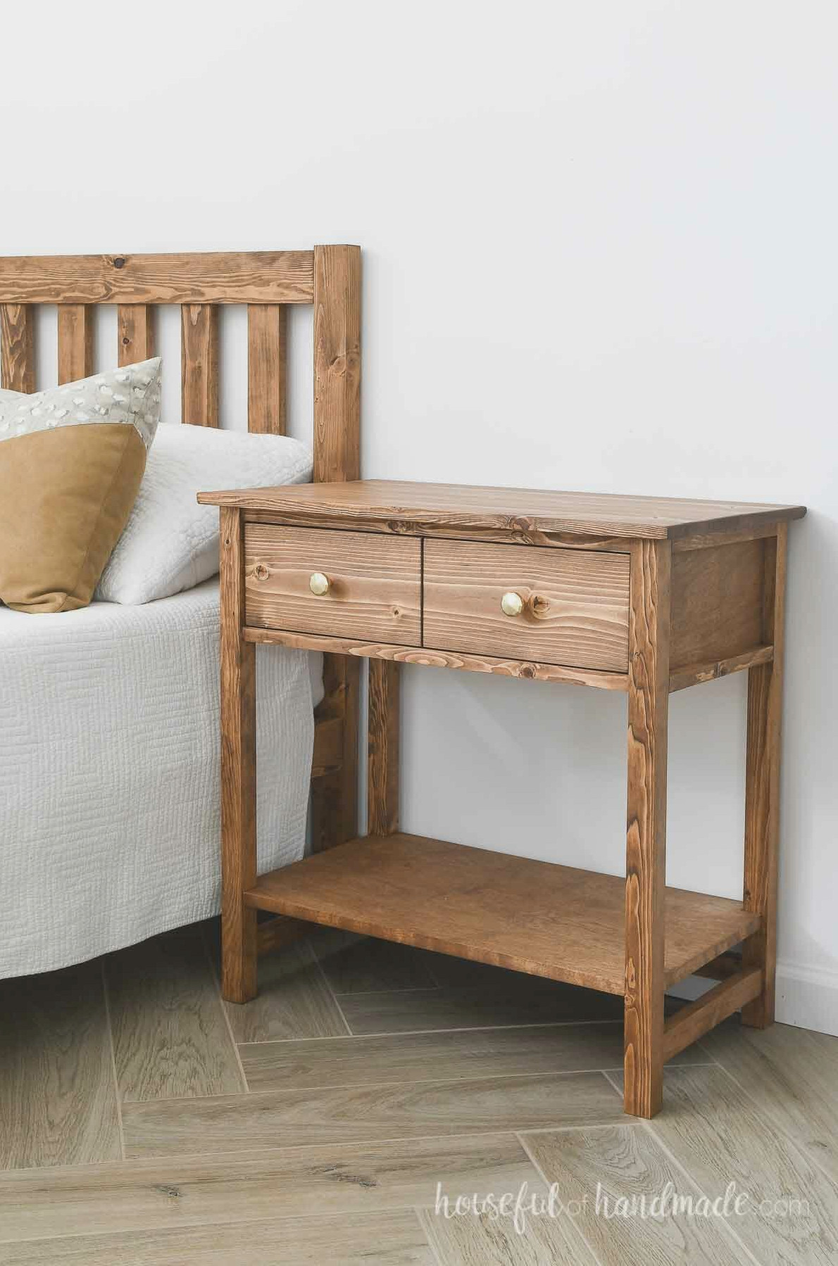 Attractive DIY nightstand resembling a Pottery Barn farmhouse 2 drawer nightstand beside a bed.